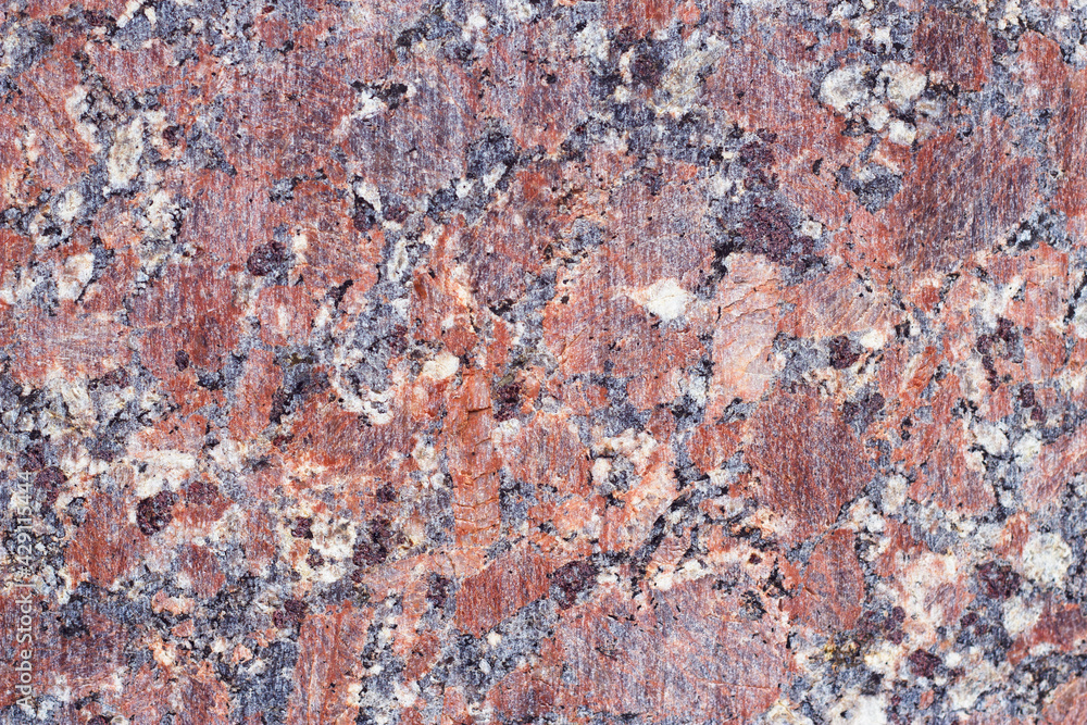 Red granite texture with natural drowings - close up of flat surface. Natural stone background. Table surface and exterior material. Contrast colorful wall. Red granite texture with natural drowings - close up of flat surface. Natural stone background. Table surface and exterior material. Contrast colorful wall.
