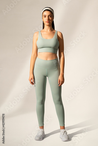 Canvastavla Woman in green sports bra and yoga pants activewear apparel full body