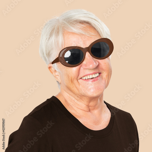 Happy senior woman wearing black oval sunglasses for summer apparel portrait © Rawpixel.com