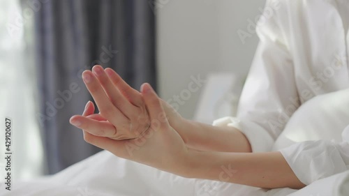 Wallpaper Mural Close up of woman hand holding and applying moisturiser, Body lotion in bedroom. Torontodigital.ca