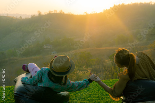 Mother  and daughter in the valley at sunset