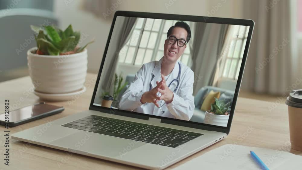 Close Up Video Call With Asian Doctor On Laptop Computer Close Up Video Call With Asian Doctor On Laptop Computer