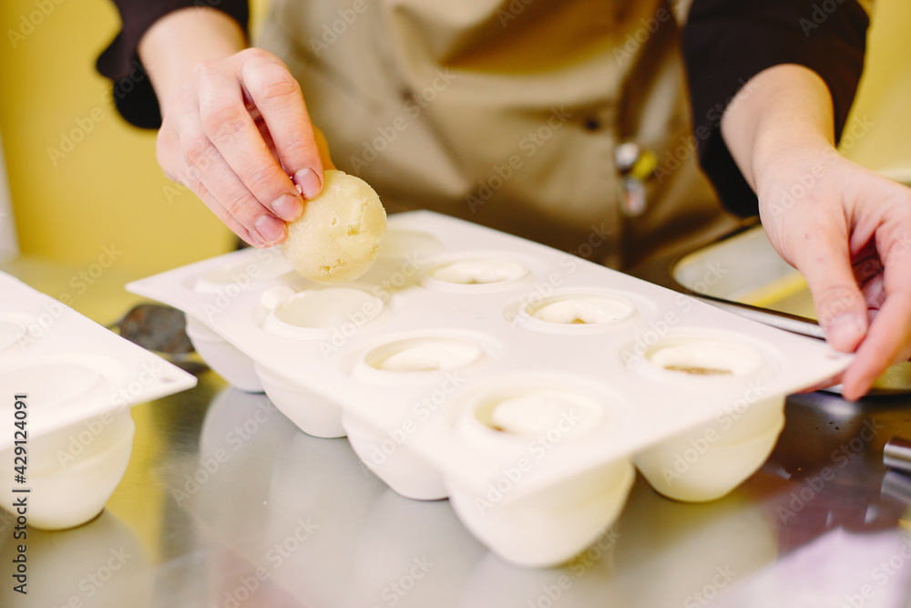 Woman working on confectionery in kitchen Woman working on confectionery in kitchen