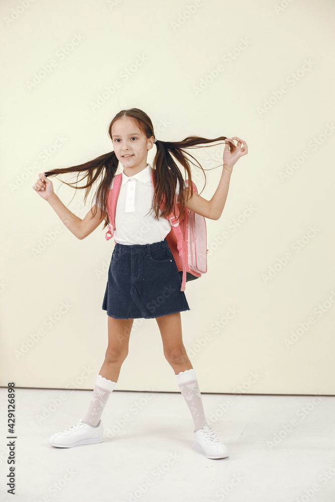 Little girl holding books isolated in studio Little girl holding books isolated in studio