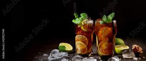 Photography Fresh made longdrink Cuba libre cocktail on dark background.