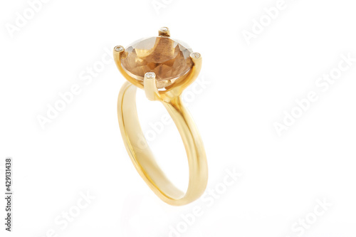 Ring in yellow gold with a smok topaz stone and diamonds on a white background