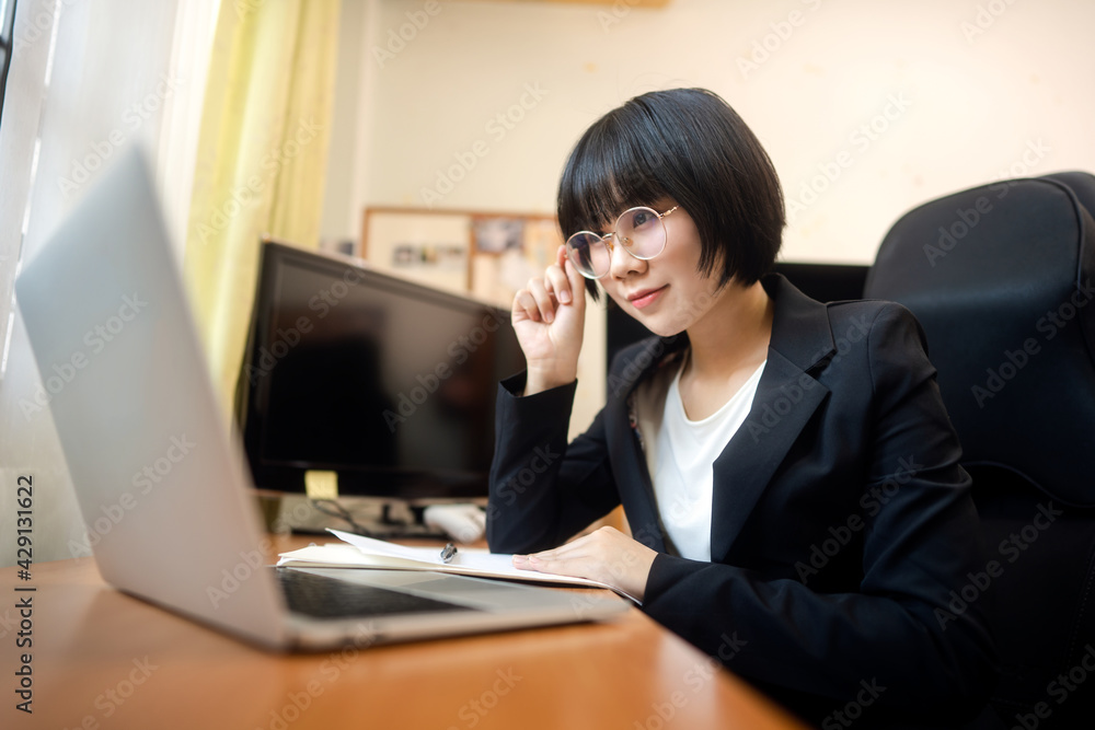 Young adult asian woman using laptop computer for video call work at home on day. Young adult asian woman using laptop computer for video call work at home on day.