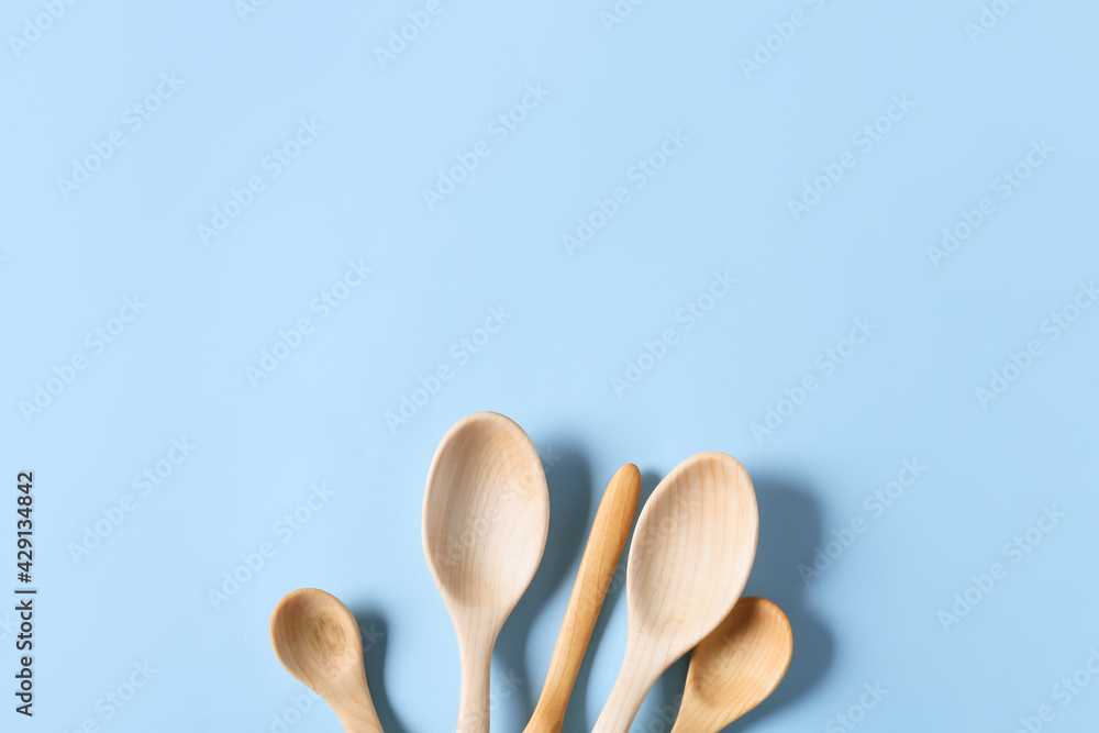Different wooden spoons on color background Different wooden spoons on color background