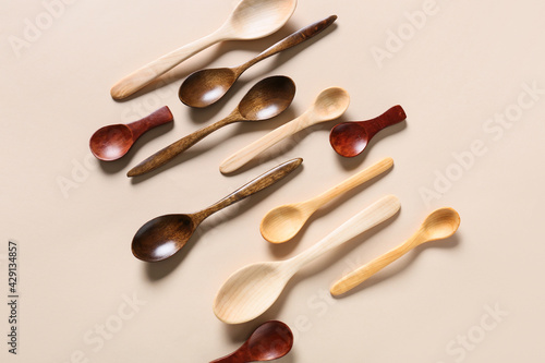 Different wooden spoons on light background