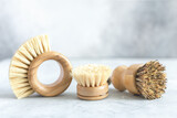 Set of wooden bamboo brushes for washing dishes and cleaning home. Zero waste eco friendly cleaning concept. Soft focus - Image