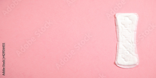 Menstrual pad on a pink background.