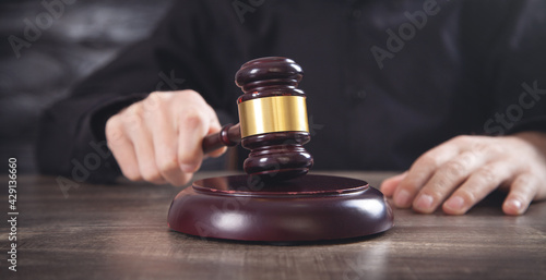 Male judge in a courtroom striking the gavel.