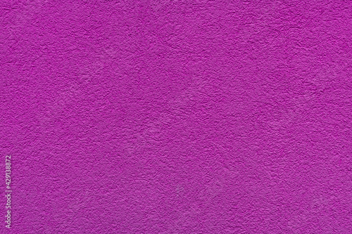 Purple plaster facade texture background. External facade of the building, plaster with clear texture.