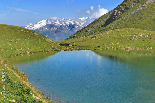 beautiful lake in alpine mountain lake with snowy peak mountain background