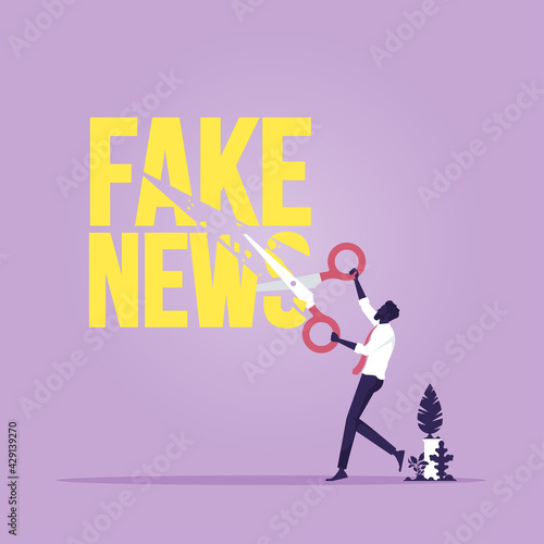 Stop fake news and misinformation spreading on internet and media concept, Businessman use scissors cutting fake news text