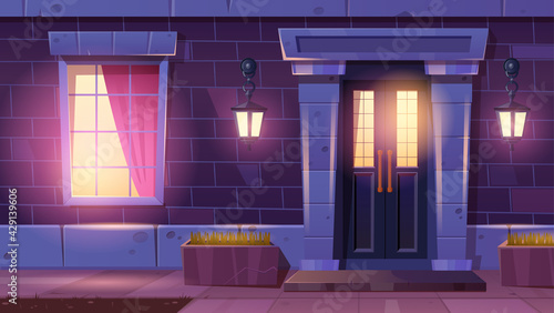 House facade with door and window at night. Home entrance with light from lanterns on brick wall and window. Vector cartoon facade of vintage residential building with front door in stone frame