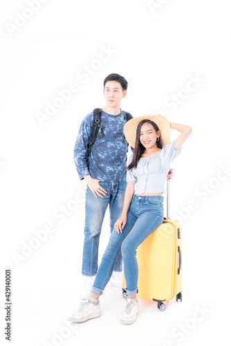 Young couple packing for vacation travel on isolated white background. Young Asian Male and female are preparing for the journey happily on white background.