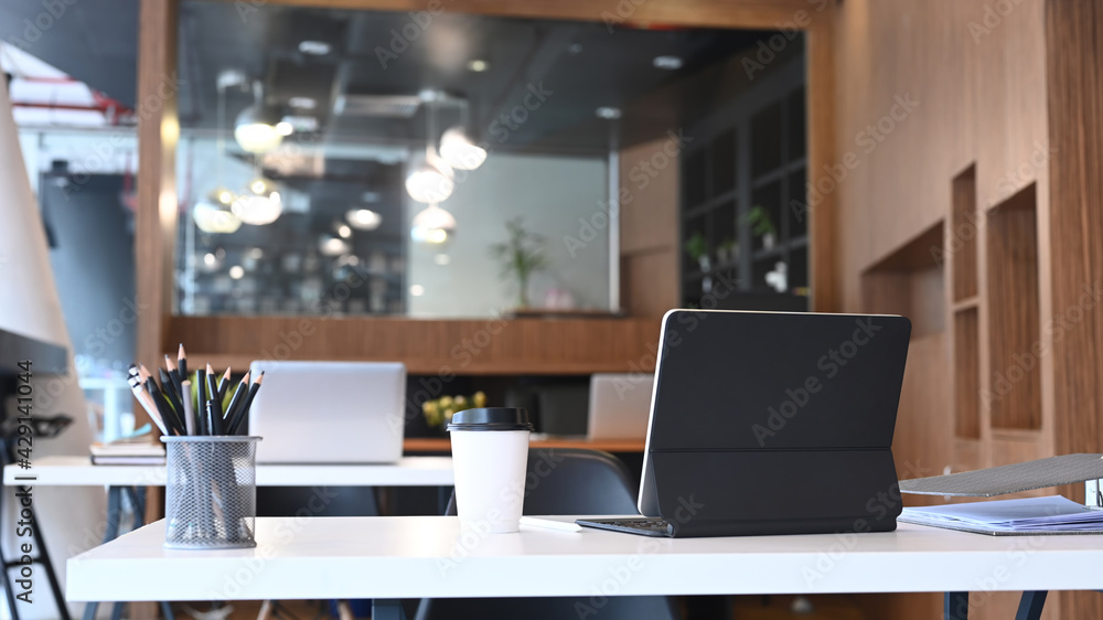 Modern office room with computer tablet and office supplies on white desk. StockFoto Adobe Stock