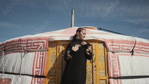 girl in national dress near yurt against sky sunny weather photo