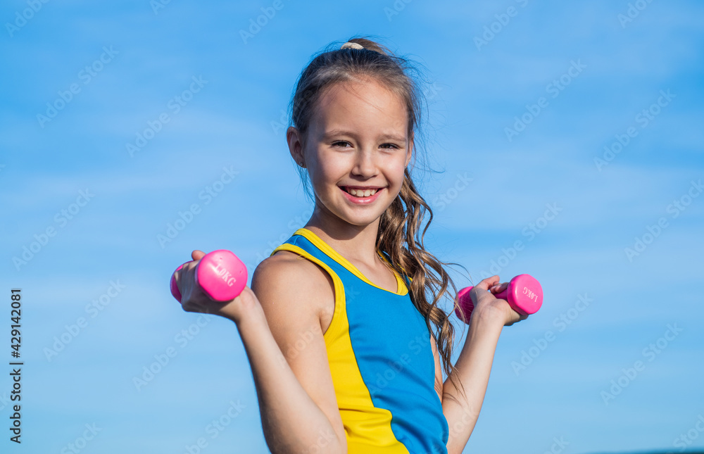happy teen girl wear sportswear for training with barbells on sky background, physical training happy teen girl wear sportswear for training with barbells on sky background, physical training