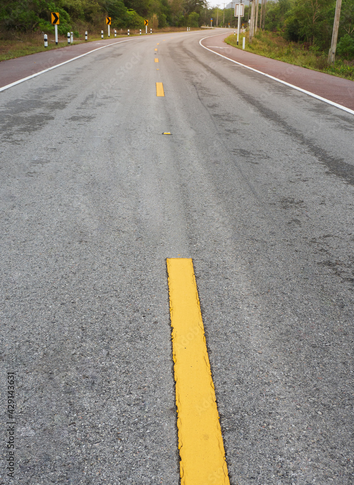 Fototapeta premium Winding road in countryside in rural southern Thailand.