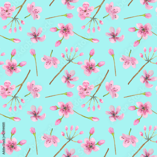 Seamless pattern with cherry flowers and buds on a blue background. The illustration is hand-drawn in watercolor. Can be used on fabric, covers, wrapping paper, scrapbooking, wallpaper.