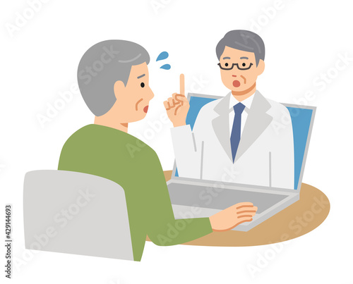 パソコンでオンライン診療を受ける困り顔のシニア男性