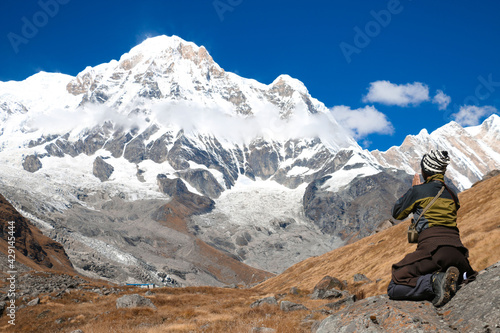 Trekker thanking after observing sunrise from Annapurna Base Camp © manish