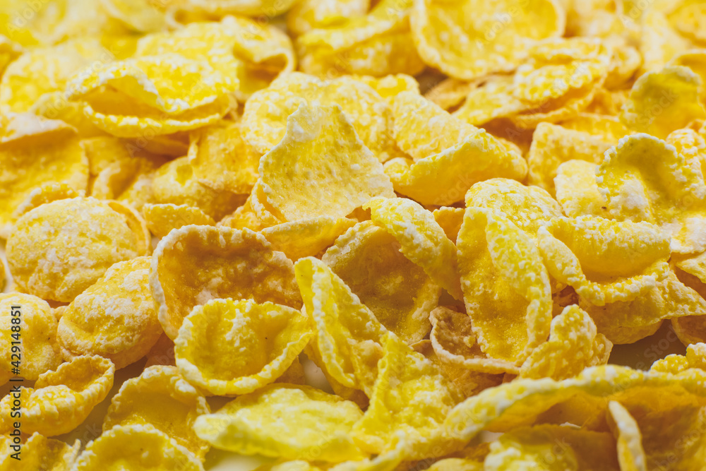 Yellow Cornflakes close up photo, Food texture background, top view. Macro shot. Perfect breakfast. Yellow Cornflakes close up photo, Food texture background, top view. Macro shot. Perfect breakfast.