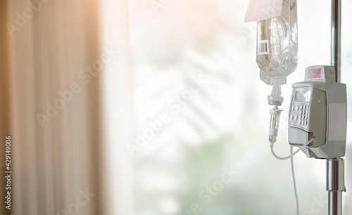 Close up adjust infusion pump set iv fluid intravenous drop saline drip.