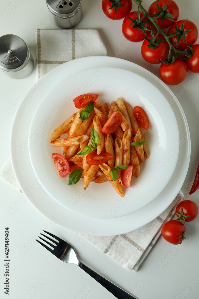 Concept of tasty food with pasta with tomato sauce on white background Concept of tasty food with pasta with tomato sauce on white background