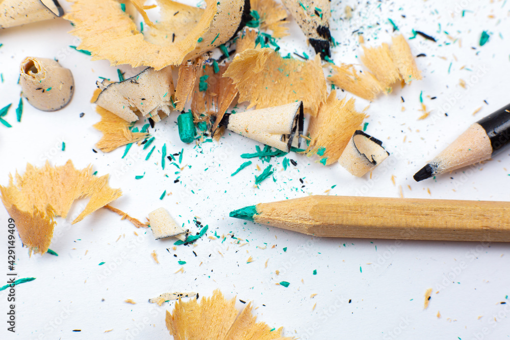 Shavings and a broken pencil.  Graphite on white background. Close up, Macro photo. Back to school.