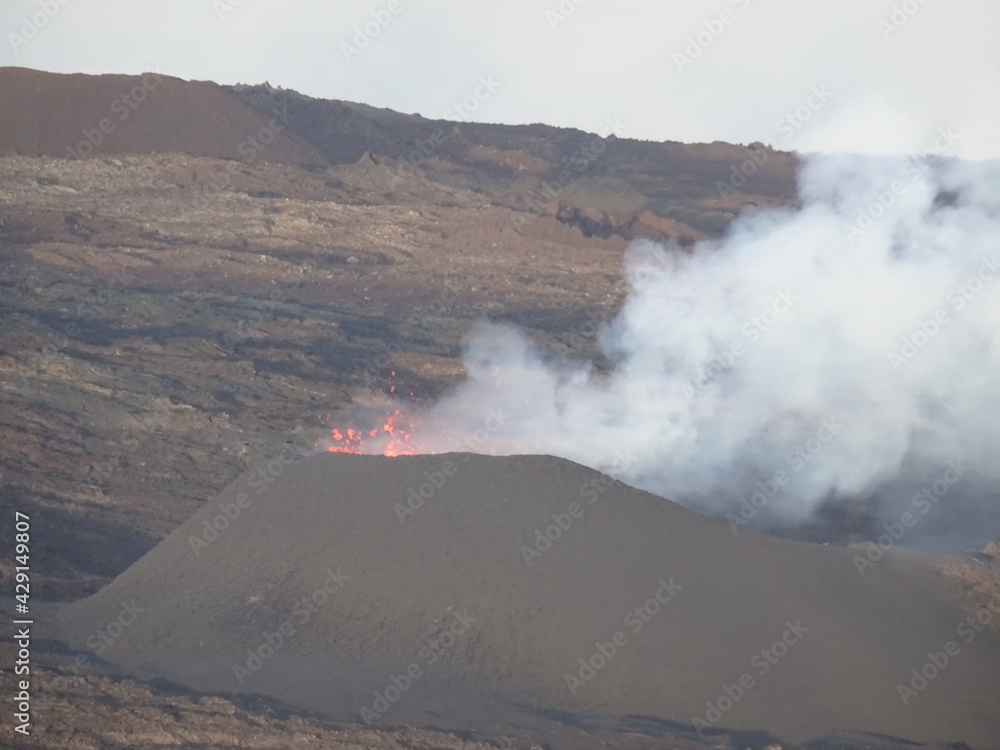 Fototapeta premium smoke and red lava erupting from the volcano on the tropical island of La Réunion, France