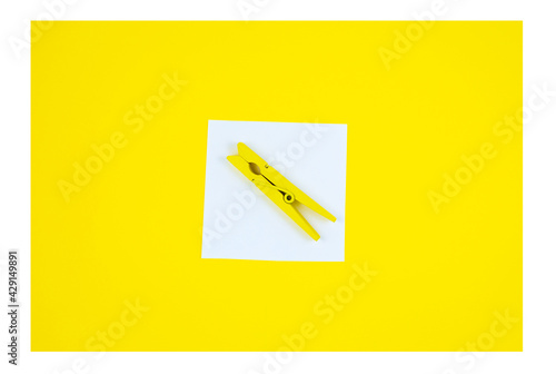 To Do List Sticker with yellow wooden clothespin. Close up of reminder note paper on the yellow background. Copy space. Minimalism, original and creative photo. Vertical Wallpaper for smartphone.