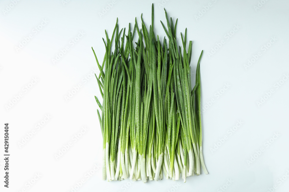 Fresh green onion with water drops on white background