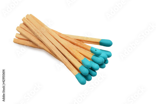 Fotografie Matches wooden stics with turquoise sulfur in bunch isolated on white
