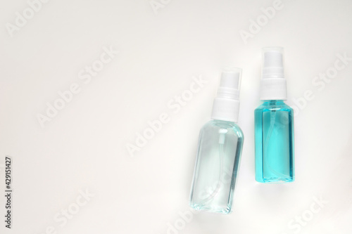 Top view above hand sanitizer spray bottle blue Isopropyl alcohol liquid for medical purpose and Anti coronavirus COVID-19 (Ethanol or ethyl alcohol on isolated white grey background with copy space