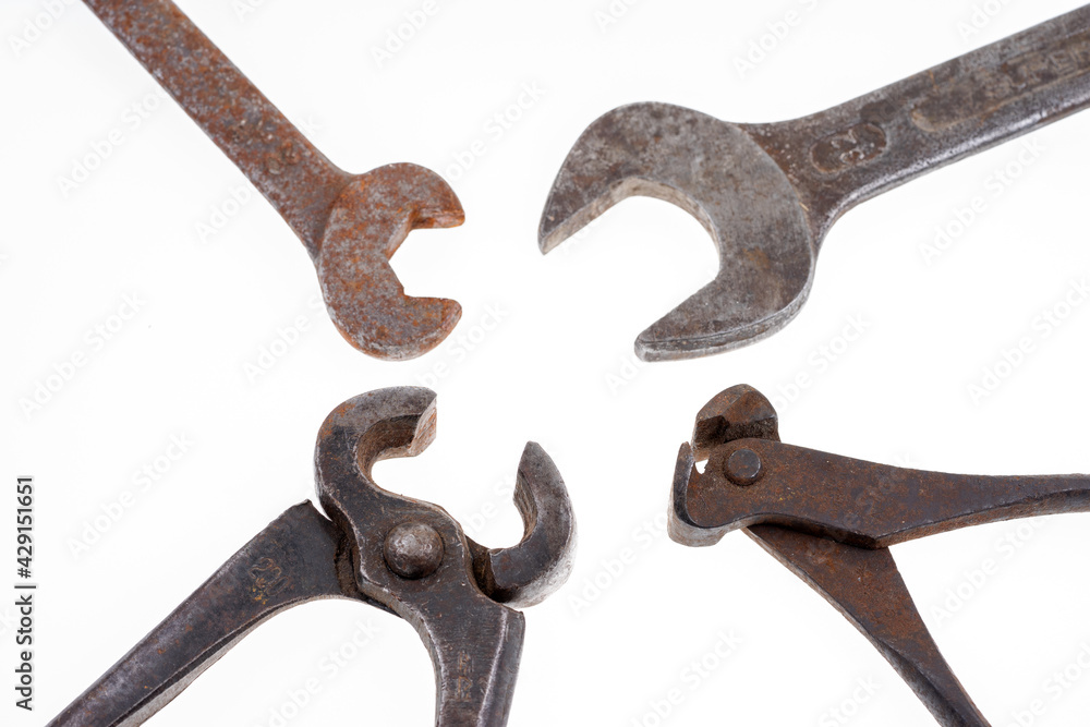 Different rusty pliers and spanners isolated on white background