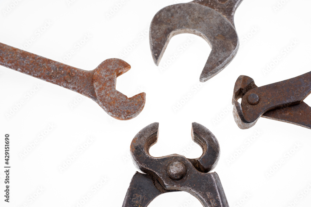 Different rusty pliers and spanners isolated on white background