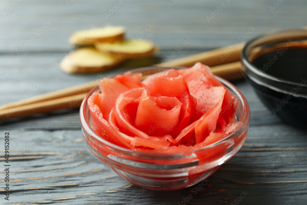 Bowl of pickled ginger, soy sauce and chopsticks on wooden table Bowl of pickled ginger, soy sauce and chopsticks on wooden table