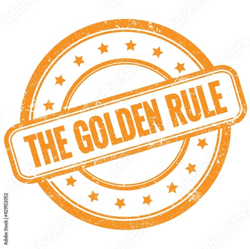 THE GOLDEN RULE text on orange grungy round rubber stamp.