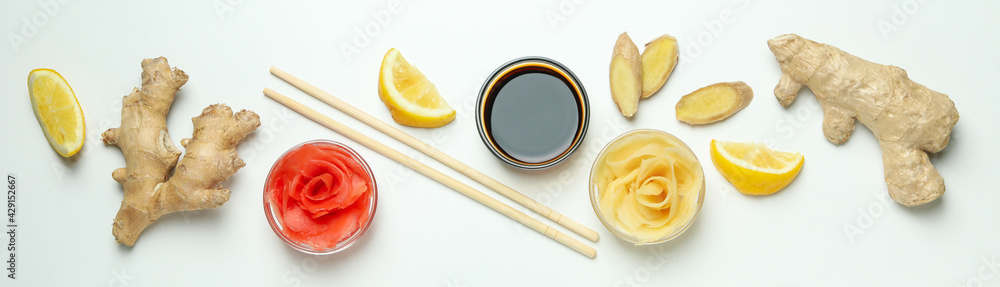 Pickled ginger, soy sauce, ginger, chopsticks and lemon on white background Pickled ginger, soy sauce, ginger, chopsticks and lemon on white background