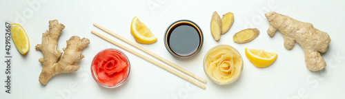 Pickled ginger, soy sauce, ginger, chopsticks and lemon on white background