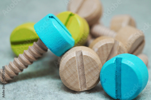 colored wooden screws bolts repair tool children's toy interesting background wallpaper 