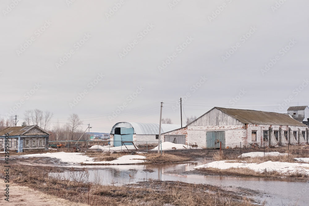 abandoned farm in spring during floods. Empty country lands.