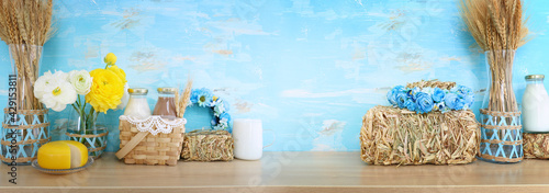 image of dairy products, crops and hay piles over wooden background. Symbols of jewish holiday - Shavuot photo