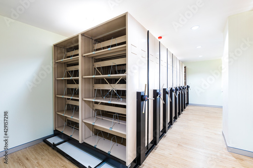 Empty white metal shelves in storage room