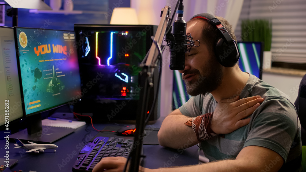 Winner streamer playing online space shooter game in gaming room using RGB keyboard and system desktop. Cyber performing on powerful pc talking with players on chat open during live competition Winner streamer playing online space shooter game in gaming room using RGB keyboard and system desktop. Cyber performing on powerful pc talking with players on chat open during live competition