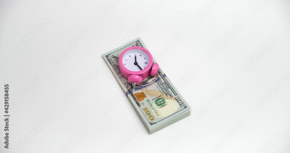 Time is money, gloved hands pull out a watch and a wad of dollars. Time is money, gloved hands pull out a watch and a wad of dollars.