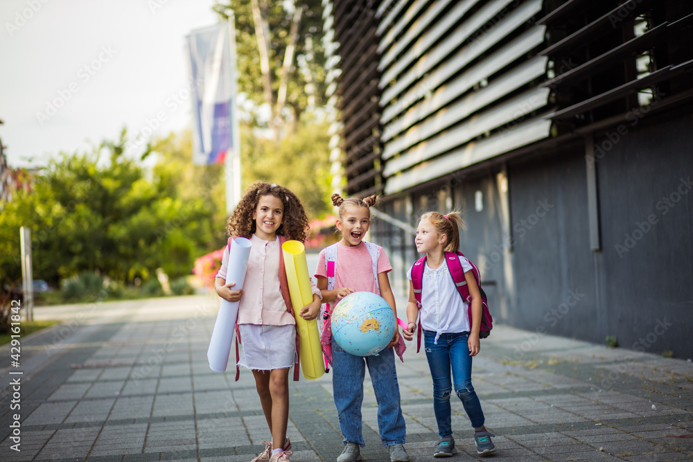 © liderina - Adorable elementary age best friends wait outside school.